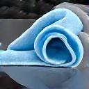 A gloved hand wiping a car panel with a microfiber towel.